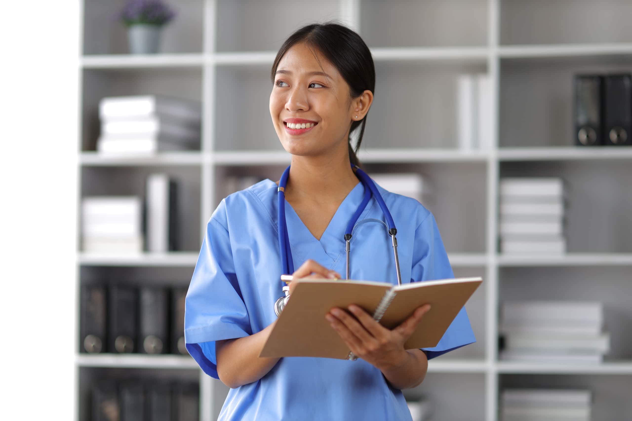 Asian nurse smiling and looking off to the side